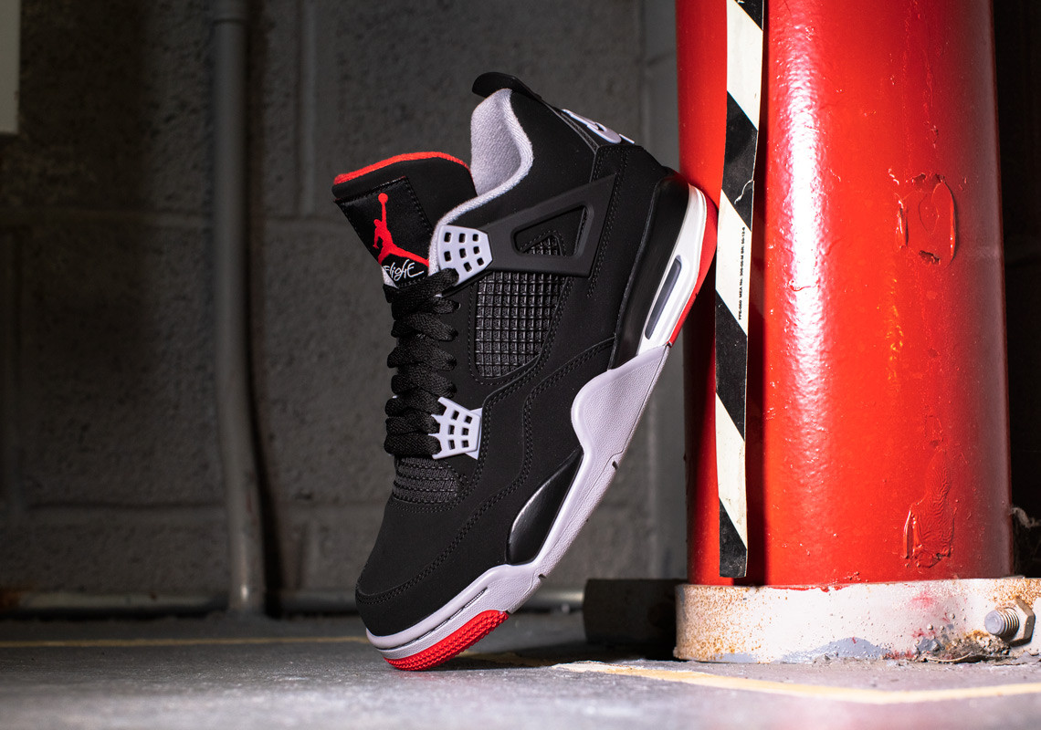 Air Jordan 4 Bred 2019 in-hand close-up showing materials and construction quality