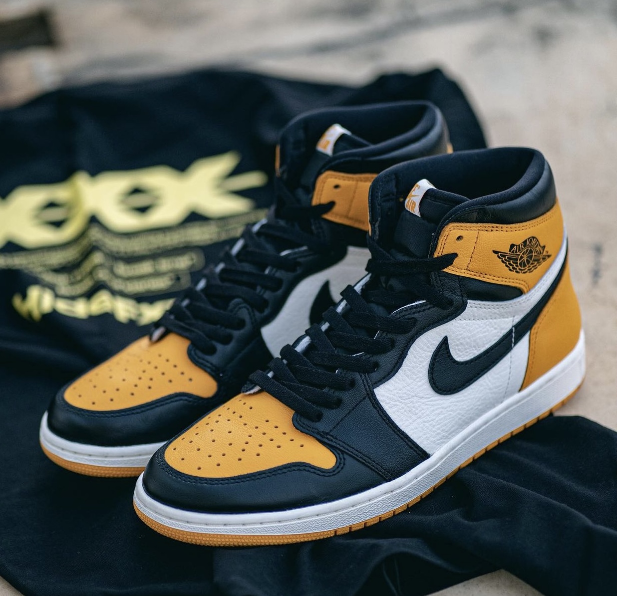 Air Jordan 1 Yellow Toe pair on dark background