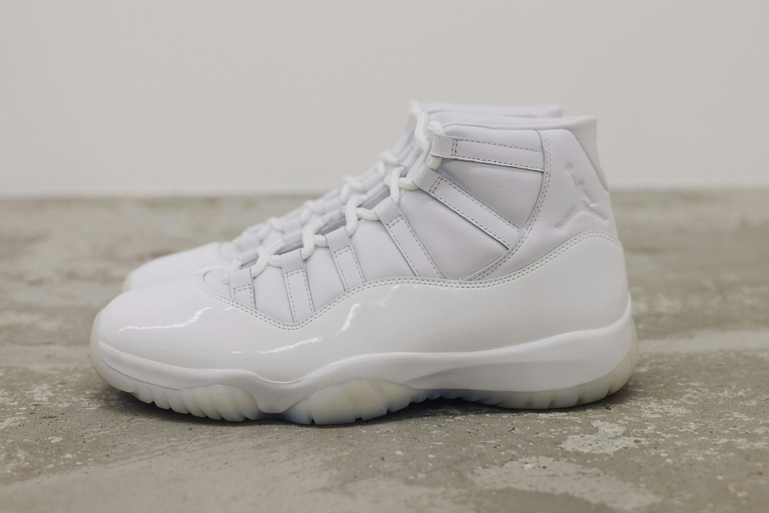 CDG Homme Plus x Air Jordan 11 detailed product shot showing embossed CDG and Jordan branding at heel